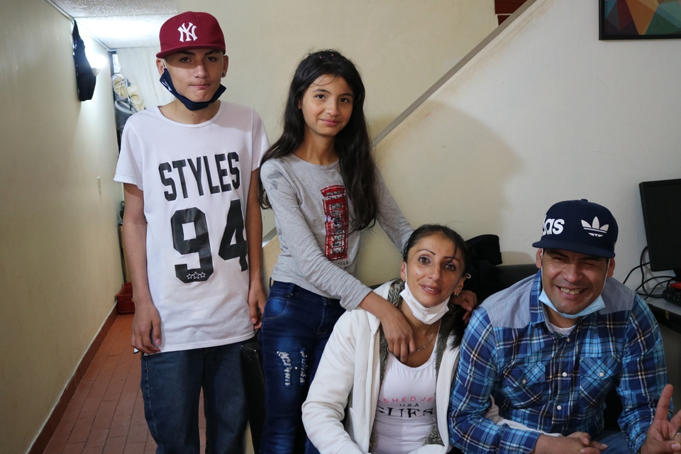 Maria with her brother and parents in Colombia