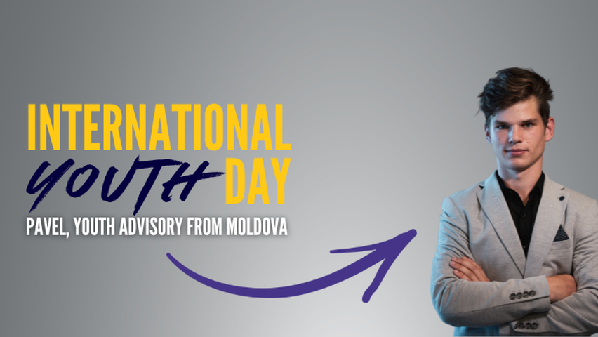 Pavel next to banner saying 'International Youth Day'