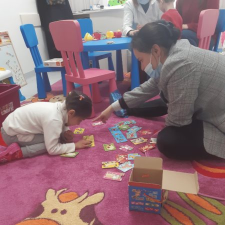 Adriana, a young girl with cerebral palsy playing 